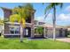 Elegant two-story home boasting a stone facade, three-car garage, and well-manicured lawn at 4002 Scarlet Branch Rd, Orlando, FL 32824