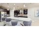 Kitchen features pendant lighting, stainless appliances, quartz countertops, bar seating and dark cabinets at 4002 Scarlet Branch Rd, Orlando, FL 32824