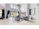 Bright living room with high ceilings, modern fireplace, and views of the backyard at 4002 Scarlet Branch Rd, Orlando, FL 32824