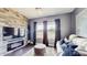 Comfortable living room with stone accent wall, plush seating, and natural light at 4002 Scarlet Branch Rd, Orlando, FL 32824