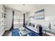 Comfortable living room with pendant lighting, light gray walls, dark floors and a large front window at 4002 Scarlet Branch Rd, Orlando, FL 32824