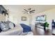 Comfortable main bedroom suite with a modern design, ceiling fan and television at 4002 Scarlet Branch Rd, Orlando, FL 32824
