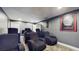 Home theater room with theater seating and movie posters at 4002 Scarlet Branch Rd, Orlando, FL 32824