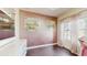 Office with light pink walls, white trim, desk and chair at 4002 Scarlet Branch Rd, Orlando, FL 32824