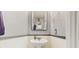 Simple powder room with pedestal sink and modern mirror at 4002 Scarlet Branch Rd, Orlando, FL 32824