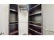 Organized walk-in closet featuring dark wood shelving and ample storage space for efficient and stylish storage solutions at 4002 Scarlet Branch Rd, Orlando, FL 32824