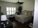 Comfortable bedroom with warm tones features hardwood floors and shutters at 411 Evening Sky Dr, Oviedo, FL 32765