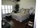 Bedroom with warm tones, hardwood floors, shutters and a queen size bed at 411 Evening Sky Dr, Oviedo, FL 32765