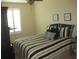 Bedroom with neutral walls and a black, white, and yellow striped comforter at 411 Evening Sky Dr, Oviedo, FL 32765