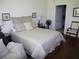 Bedroom with neutral color palette features a comfortable queen-sized bed and hardwood floors at 411 Evening Sky Dr, Oviedo, FL 32765