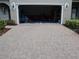 Spacious garage access via brick driveway, offering ample parking and storage at 411 Evening Sky Dr, Oviedo, FL 32765