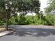 Expansive parking lot with mature trees providing shade and a well-maintained surface, showcasing accessibility at 411 Evening Sky Dr, Oviedo, FL 32765