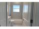 Clean, bright bathroom featuring a tub-shower combo and neutral tile at 4111 Sw 166Th Place Rd, Ocala, FL 34473