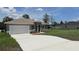 Beautiful single-story home showcasing a long driveway and manicured front lawn at 4111 Sw 166Th Place Rd, Ocala, FL 34473