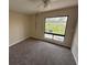 Bedroom with a ceiling fan, neutral walls, carpet and a large window with a view to the outside at 4328 Aqua Vista Dr # B, Orlando, FL 32839