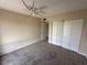 Bedroom featuring carpet, a ceiling fan, closet with sliding doors and view into the hallway at 4328 Aqua Vista Dr # B, Orlando, FL 32839