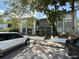 Condominium building with a gray exterior, staircase, and lush trees providing shade at 4328 Aqua Vista Dr # B, Orlando, FL 32839