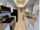 Well-equipped kitchen featuring stainless steel appliances, granite countertops, and white cabinets at 4328 Aqua Vista Dr # B, Orlando, FL 32839