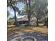 Secluded backyard showcasing a fire pit and mature trees, offering a peaceful outdoor space at 513 Rachael Ct, Oviedo, FL 32765
