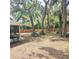 This backyard features mature trees and brick wall, creating privacy and character at 513 Rachael Ct, Oviedo, FL 32765