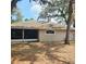 Backyard view of the home with a screened-in porch and arched window at 513 Rachael Ct, Oviedo, FL 32765
