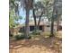 Back view of home with a screened-in patio, and mature trees at 513 Rachael Ct, Oviedo, FL 32765