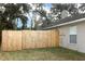 View of the home's backyard with a wood fence and exterior wall at 513 Rachael Ct, Oviedo, FL 32765