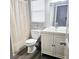Bright bathroom with wood-look floors, classic white vanity, and shower with curtain at 513 Rachael Ct, Oviedo, FL 32765