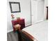 Cozy bedroom with gray laminate floors, stylish mirror, and red accent cabinet at 513 Rachael Ct, Oviedo, FL 32765