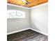 Empty bedroom with wood-look floors, neutral walls, and a unique wood ceiling at 513 Rachael Ct, Oviedo, FL 32765