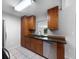 Kitchen featuring wooden cabinets, granite countertops, stainless steel appliances, and a double sink at 52 Hydrangea Ln, Debary, FL 32713
