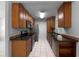 Functional kitchen with wood cabinets, stainless steel appliances, and tile flooring at 52 Hydrangea Ln, Debary, FL 32713