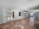 Expansive living room showcasing tile flooring, ceiling fans, and access to the kitchen and backyard at 52 Hydrangea Ln, Debary, FL 32713