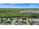 An aerial view of a neighborhood, featuring well-maintained homes with green lawns and mature trees at 5431 White Heron Pl, Oviedo, FL 32765