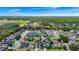 Aerial view of a residential area with homes featuring pools and green spaces with a community in the background at 5431 White Heron Pl, Oviedo, FL 32765