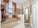 Elegant bathroom showcasing a soaking tub and a glass-enclosed shower with tile surround at 5431 White Heron Pl, Oviedo, FL 32765