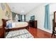 Cozy bedroom with a ceiling fan, hardwood floors, and a bay window at 5431 White Heron Pl, Oviedo, FL 32765