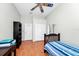 Well-lit bedroom with hardwood floors, ceiling fan, and closet at 5431 White Heron Pl, Oviedo, FL 32765
