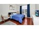 Comfortable bedroom with a large window, dark wood floors, and closet at 5431 White Heron Pl, Oviedo, FL 32765