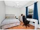 Bedroom with hardwood floors, gray and white bedspread, and a desk by the window at 5431 White Heron Pl, Oviedo, FL 32765