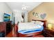 Primary bedroom with hardwood floors and en suite bath at 5431 White Heron Pl, Oviedo, FL 32765
