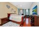 Spacious bedroom with hardwood floors, ceiling fan, and large windows at 5431 White Heron Pl, Oviedo, FL 32765