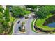 Gated community entrance with brick features, mature landscaping, and a glimpse of a tranquil pond at 5431 White Heron Pl, Oviedo, FL 32765