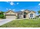 Charming single-story home with a well-manicured lawn, front-facing garage and beautiful desert landscaping at 5431 White Heron Pl, Oviedo, FL 32765