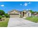 Beautiful single-story home with desert landscaping, front-facing garage and quaint architectural detail at 5431 White Heron Pl, Oviedo, FL 32765