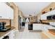 Open kitchen featuring white cabinets, granite countertops, and stainless steel appliances at 5431 White Heron Pl, Oviedo, FL 32765