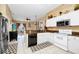 Bright kitchen with stainless steel appliances, granite countertops, and white cabinetry at 5431 White Heron Pl, Oviedo, FL 32765