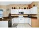 Charming kitchen featuring white cabinets, granite countertops, and modern appliances at 5431 White Heron Pl, Oviedo, FL 32765