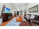 Open concept living room with hardwood floors and large windows at 5431 White Heron Pl, Oviedo, FL 32765