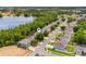 Aerial view of the home in a residential area surrounded by trees, a lake, and other homes in the neighborhood at 555 Carey Way, Orlando, FL 32825